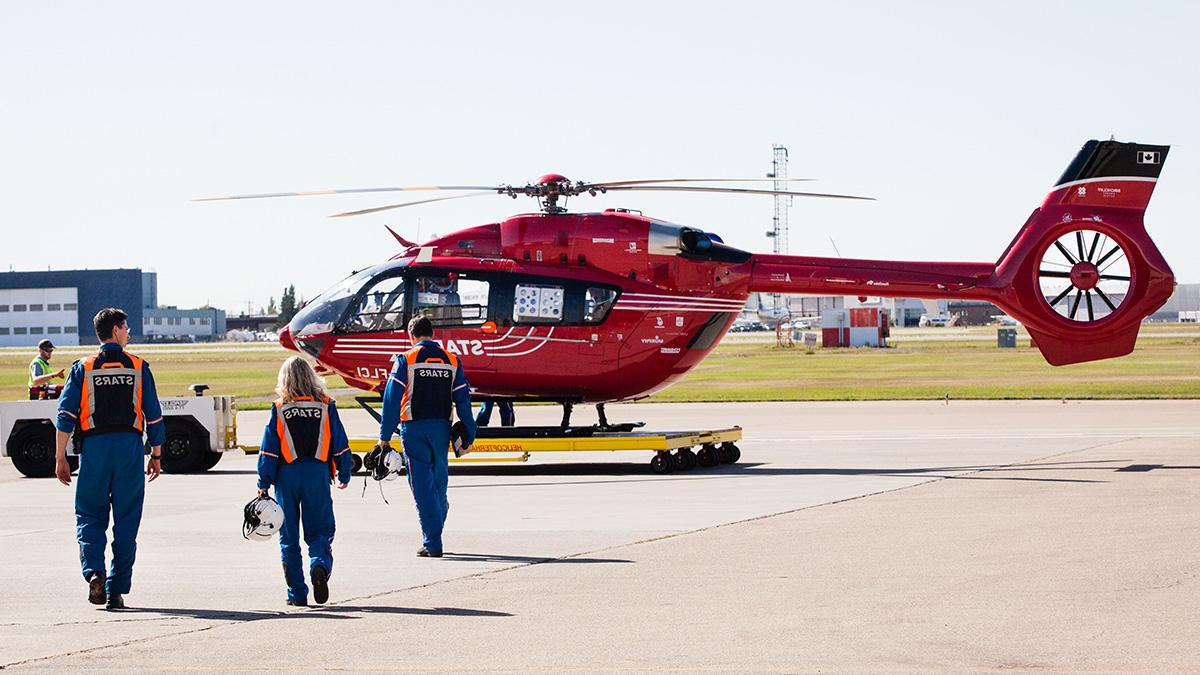 Emergency crew walking to helicopter